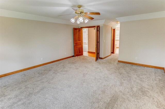 unfurnished room with light carpet, baseboards, and ceiling fan