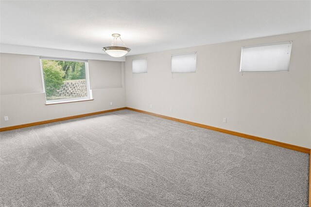 carpeted spare room with baseboards