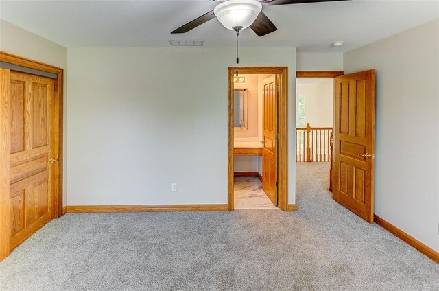 unfurnished bedroom featuring visible vents, carpet flooring, baseboards, and a ceiling fan