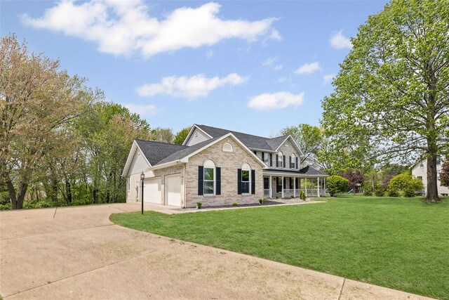 view of front of property featuring a front lawn, driveway, covered porch, brick siding, and a garage