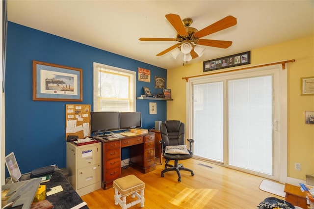 office with ceiling fan and light wood-style floors