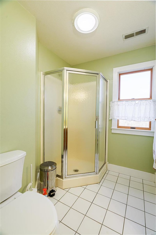 full bathroom featuring visible vents, a shower stall, and tile patterned flooring