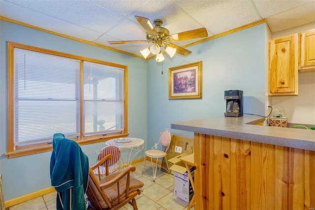interior space featuring baseboards, a wealth of natural light, light tile patterned flooring, and ceiling fan