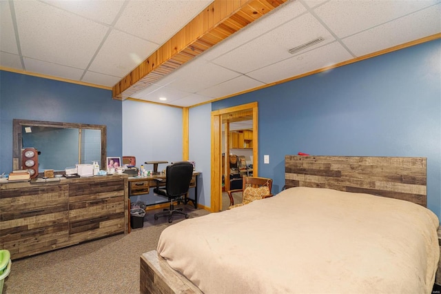 carpeted bedroom with a paneled ceiling and visible vents