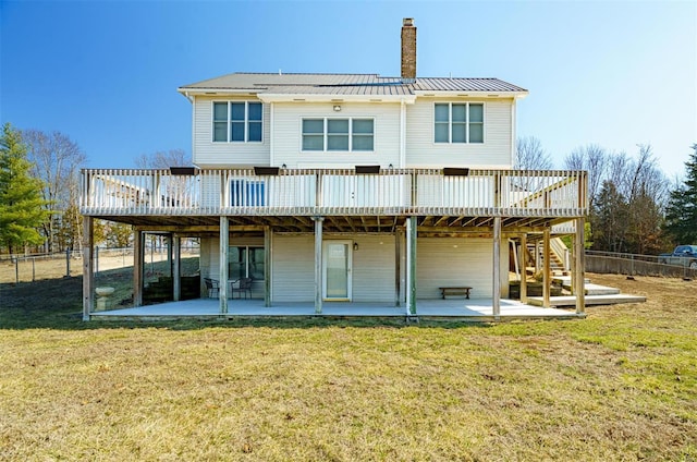 rear view of house with a patio, fence, and a wooden deck