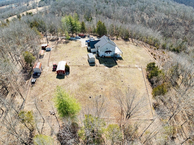 drone / aerial view featuring a rural view and a forest view