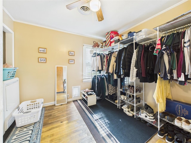 spacious closet featuring wood-type flooring, ceiling fan, and visible vents