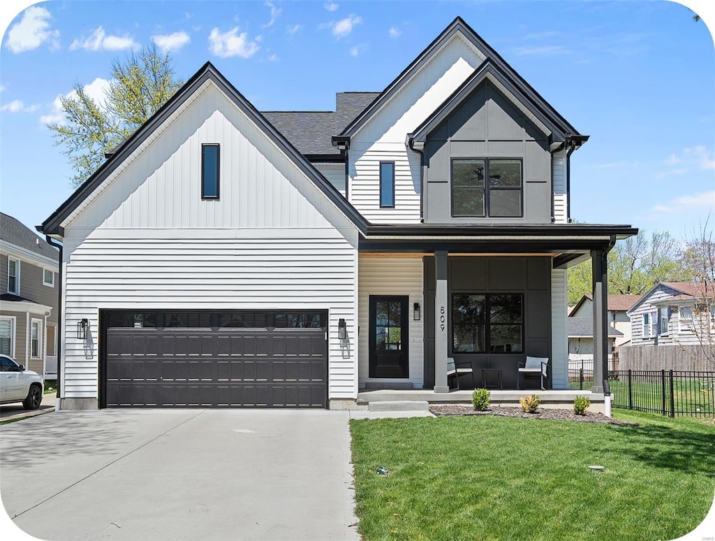 modern farmhouse style home with a front lawn, driveway, covered porch, fence, and a garage