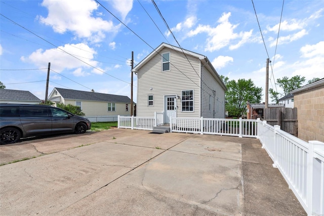 back of property featuring fence