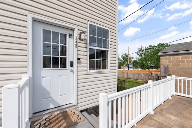 view of exterior entry with fence