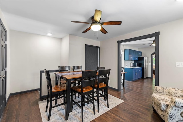 dining room featuring baseboards, a ceiling fan, and dark wood finished floors