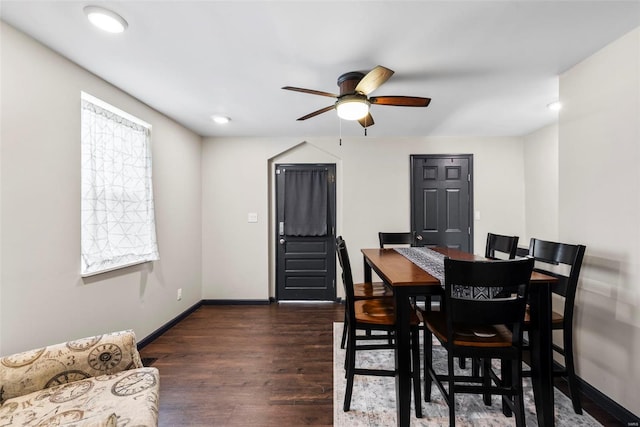 dining room with ceiling fan, baseboards, and dark wood-type flooring