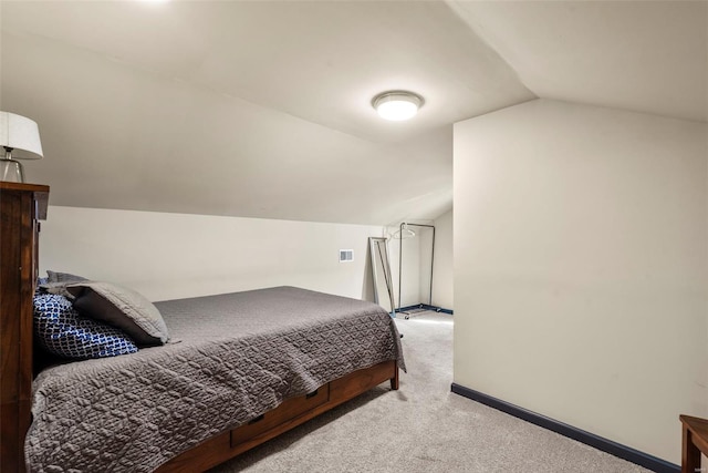 carpeted bedroom with visible vents, baseboards, and lofted ceiling