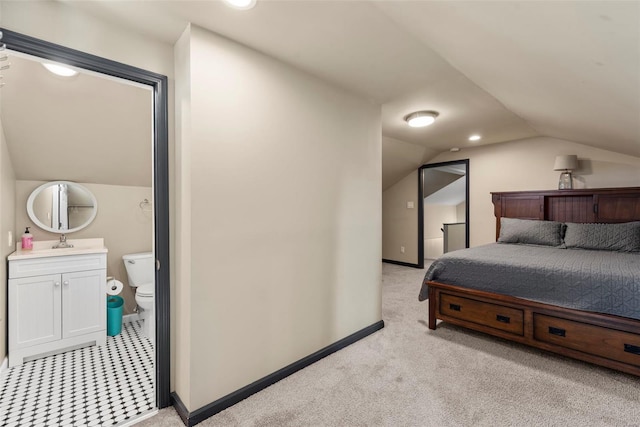 bedroom with a sink, baseboards, light carpet, and vaulted ceiling