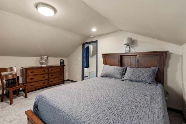bedroom featuring baseboards, light colored carpet, and lofted ceiling