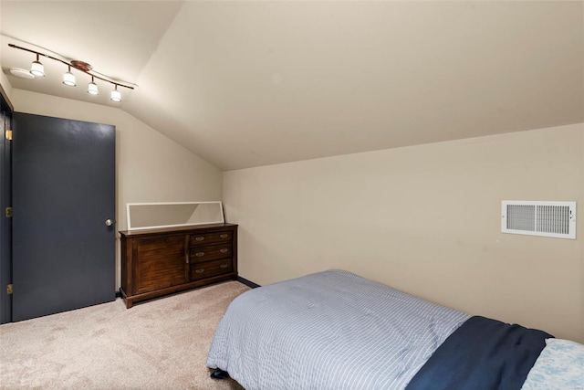 bedroom with carpet, lofted ceiling, and visible vents