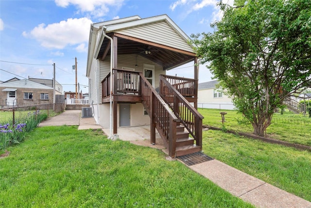 shotgun-style home featuring a ceiling fan, stairway, cooling unit, a fenced backyard, and a patio