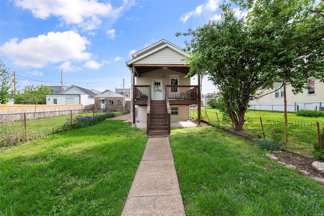 shotgun-style home with a fenced backyard, a front lawn, and stairway