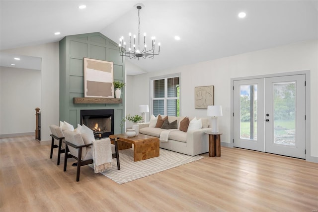 living room with recessed lighting, light wood-style flooring, a chandelier, and a large fireplace