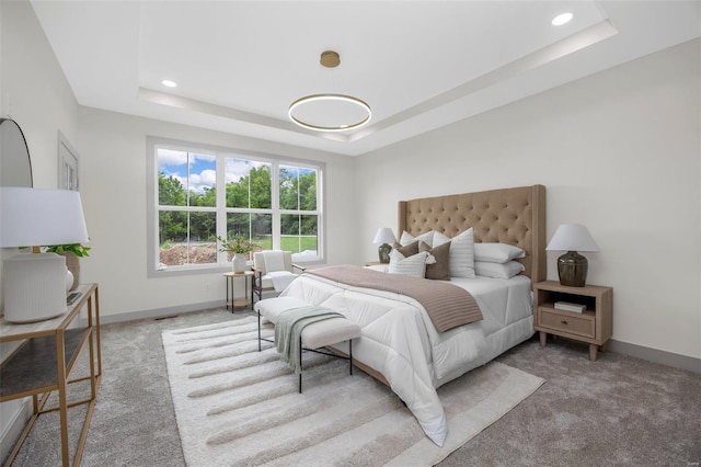 carpeted bedroom featuring recessed lighting, baseboards, and a raised ceiling