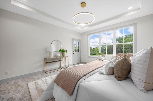 bedroom with baseboards, recessed lighting, carpet, and a tray ceiling
