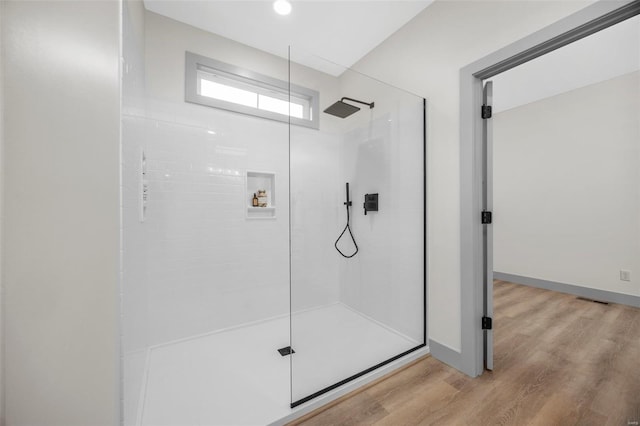 full bath featuring a walk in shower, baseboards, visible vents, and wood finished floors