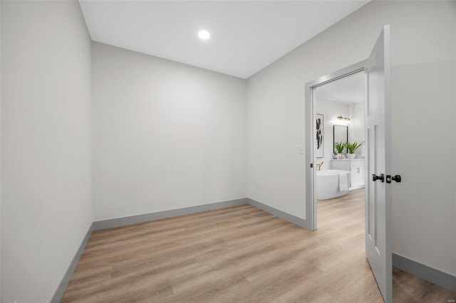 unfurnished room featuring light wood-style floors, baseboards, and recessed lighting