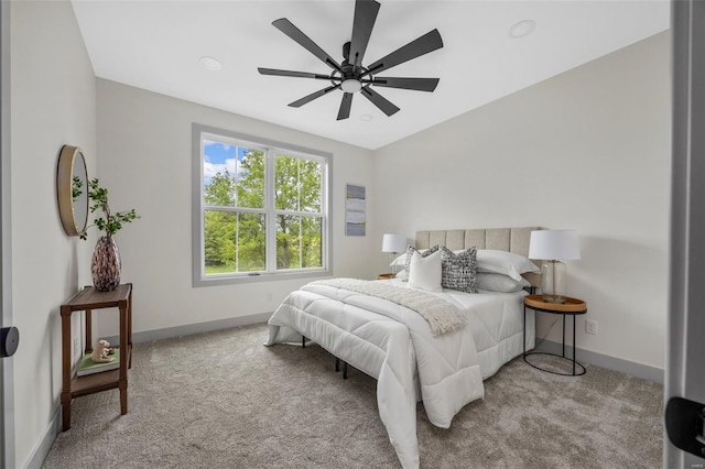 bedroom with baseboards, ceiling fan, and carpet floors