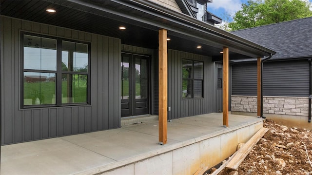 property entrance with a porch and a shingled roof
