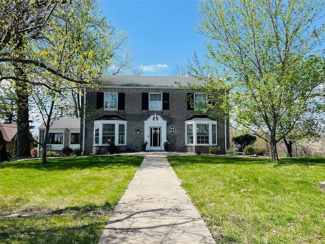 colonial-style house with a front lawn