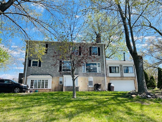 view of front facade featuring stucco siding, a front lawn, a chimney, and a garage