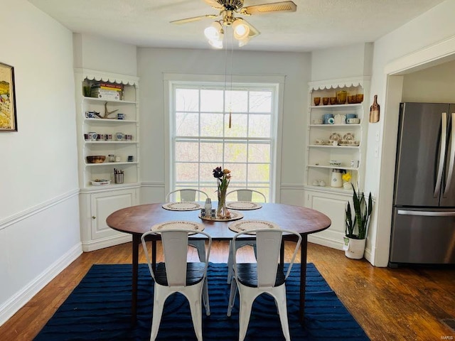 dining room with a ceiling fan and wood finished floors