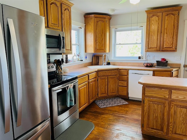 kitchen with brown cabinets, appliances with stainless steel finishes, and a sink
