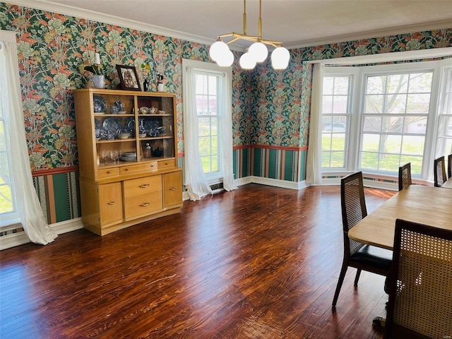 dining area with baseboards, ornamental molding, wood finished floors, and wallpapered walls