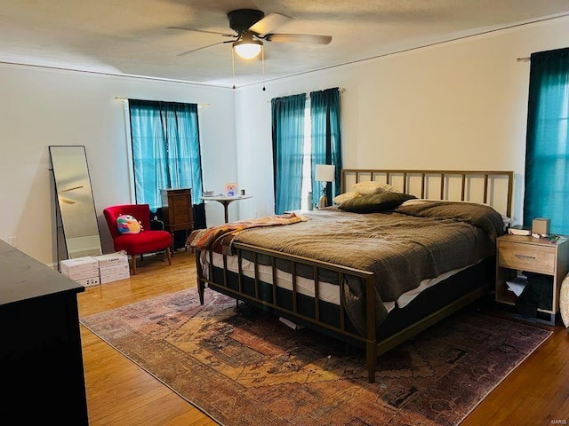 bedroom featuring wood finished floors and ceiling fan