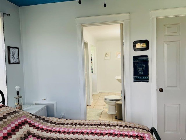 tiled bedroom featuring connected bathroom