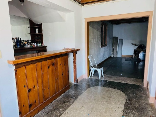 bar featuring baseboards and a dry bar