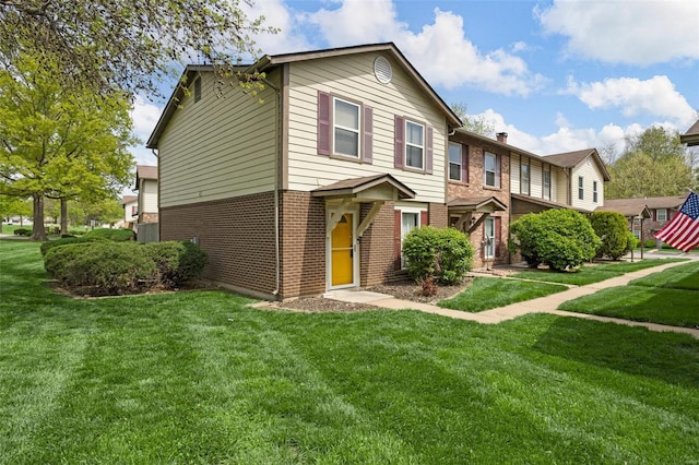 view of front of property with brick siding and a front lawn
