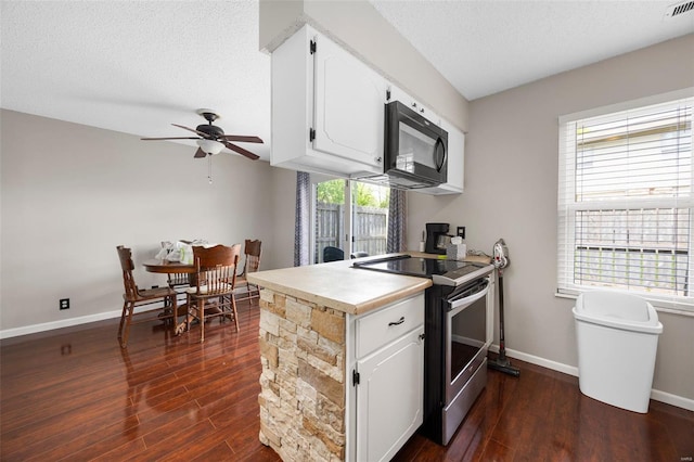 kitchen with white cabinetry, black microwave, stainless steel range with electric cooktop, dark wood-type flooring, and a ceiling fan