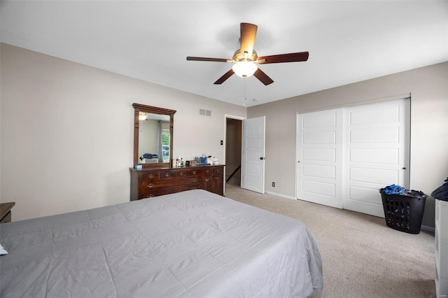 carpeted bedroom with a closet, visible vents, ceiling fan, and baseboards