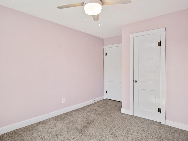 unfurnished bedroom featuring a ceiling fan, baseboards, and carpet