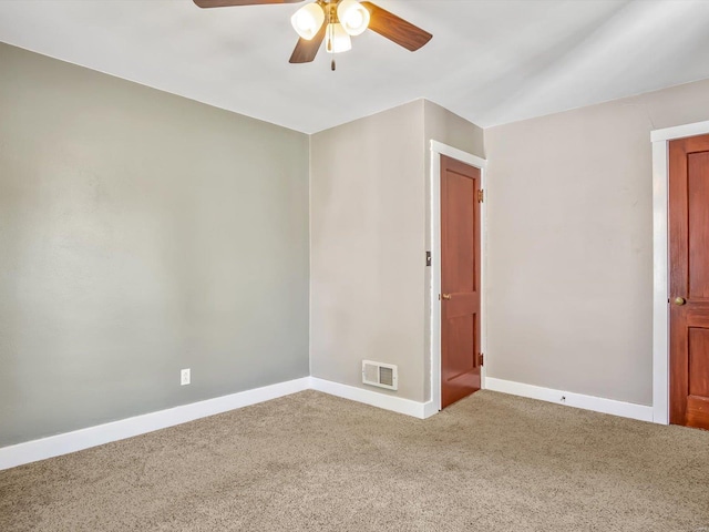unfurnished room with a ceiling fan, baseboards, visible vents, and carpet