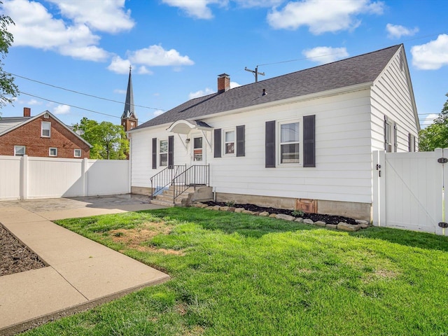 view of front of home with a patio, a gate, fence, and a front yard