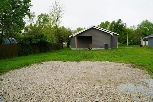 rear view of house featuring a yard, fence, and central air condition unit
