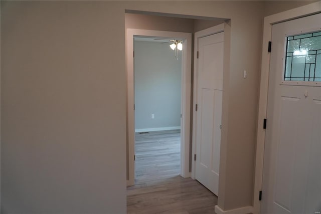 interior space with baseboards and light wood-style flooring