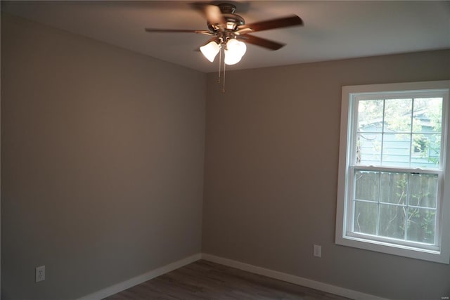 spare room featuring baseboards, a ceiling fan, and wood finished floors