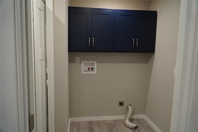 laundry area featuring cabinet space, washer hookup, electric dryer hookup, baseboards, and wood finished floors