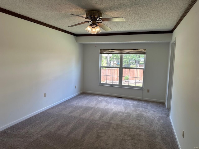 spare room with carpet floors, ornamental molding, a textured ceiling, and a ceiling fan