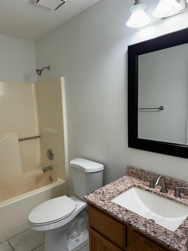 bathroom with vanity, bathtub / shower combination, toilet, and a textured ceiling