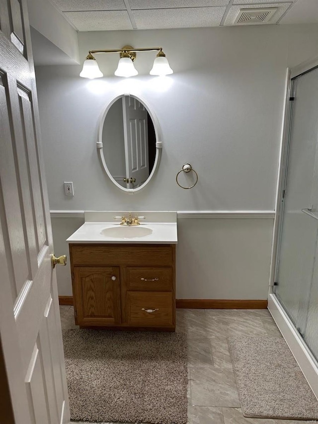 full bath with visible vents, baseboards, a shower stall, and vanity